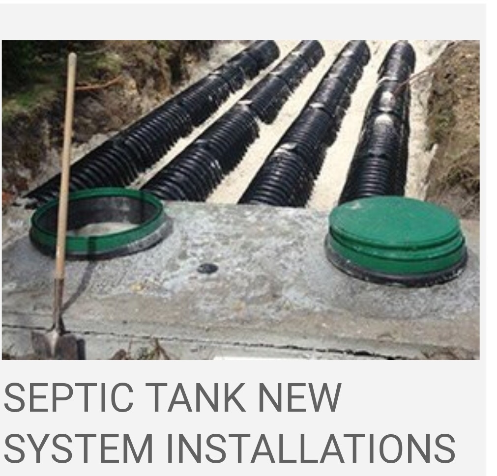 Concrete septic tank with green risers and black drain field pipes